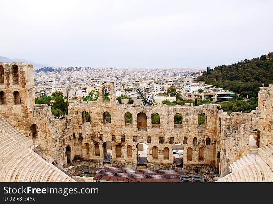 Ancient theatre of Herodes Atticus is a small building of ancient Greece used for public performances of music and poetry, below on the Acropolis and in background dwelling of metropolis Athens