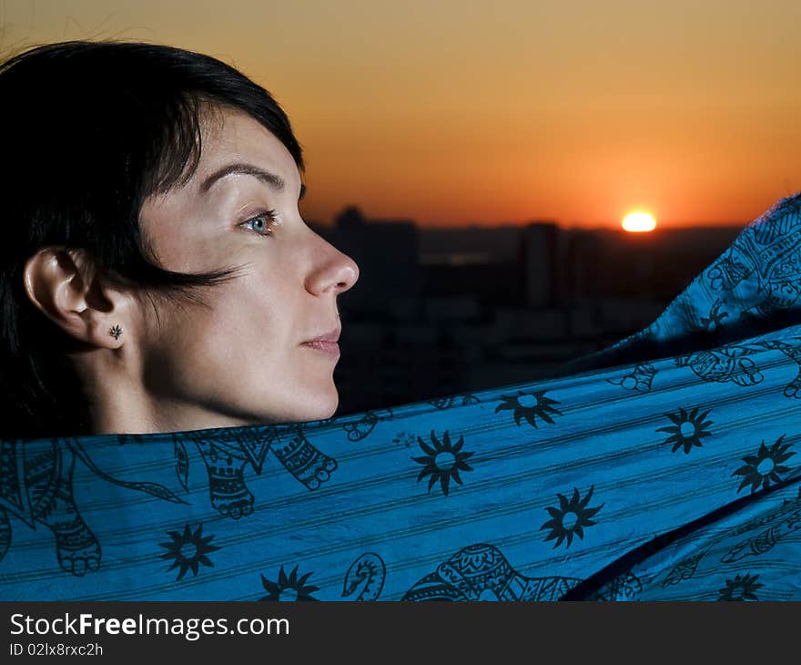 Woman in profile view against a sunset. Woman in profile view against a sunset