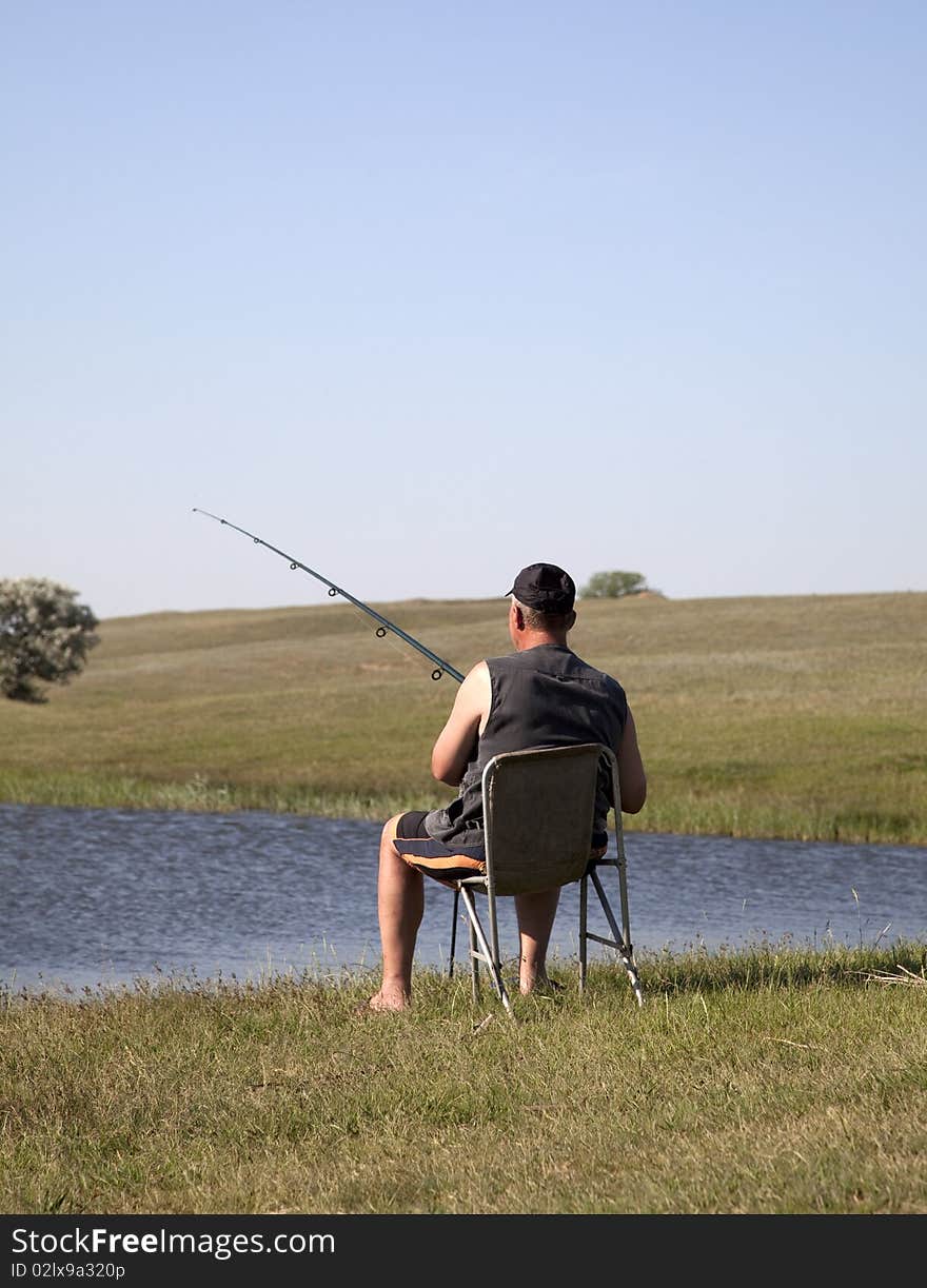 Fishman at river bay in Ukraine