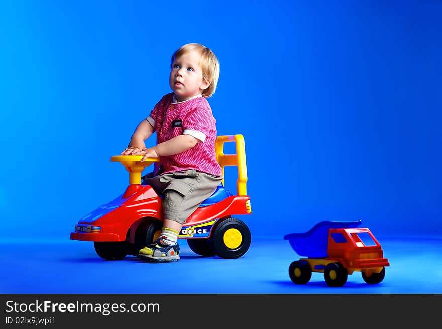 The portrait of a little boy playing with toy cars. The portrait of a little boy playing with toy cars