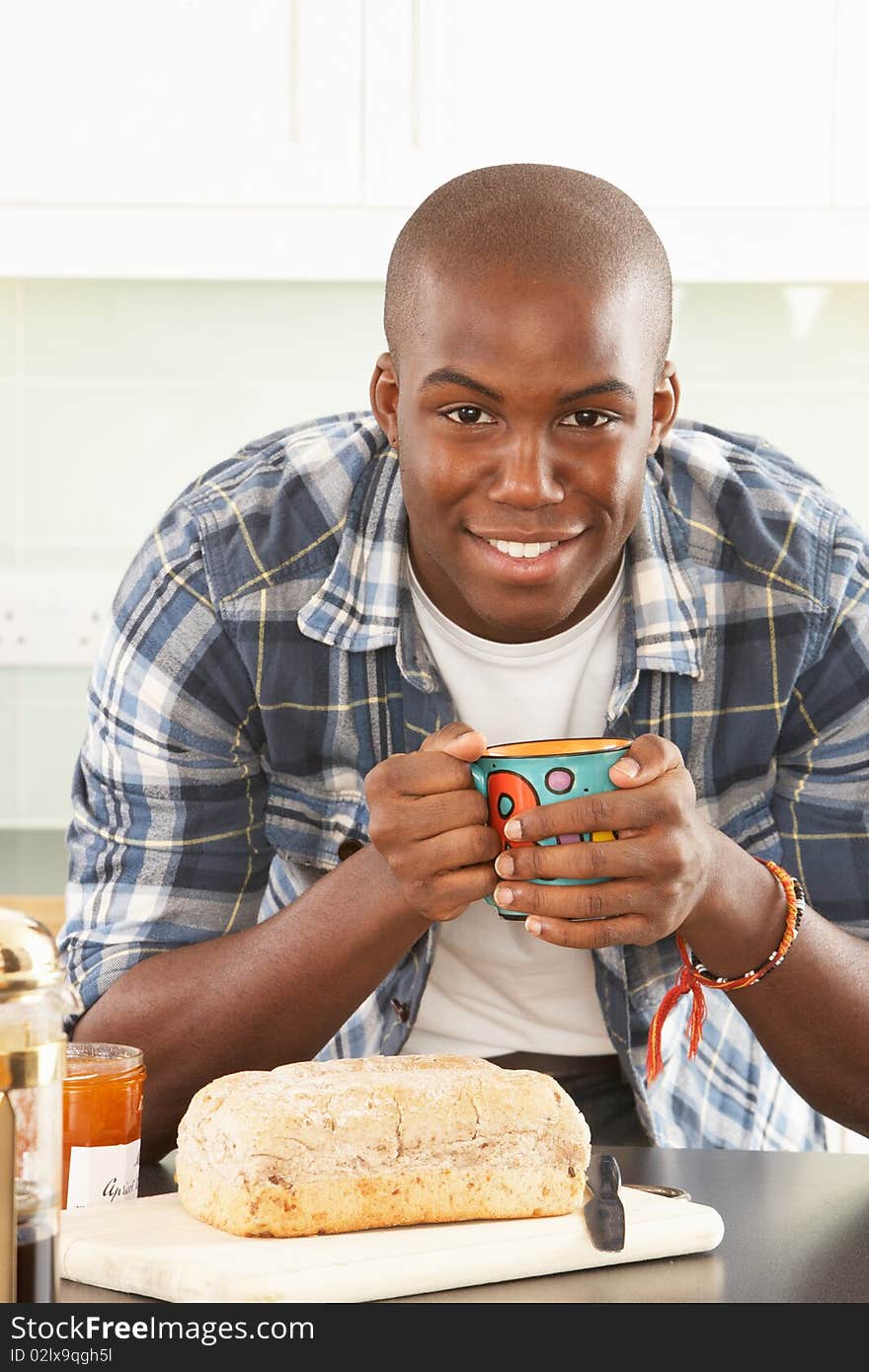 Young Man Preparing Breakfast In Modern Kitchen. Young Man Preparing Breakfast In Modern Kitchen