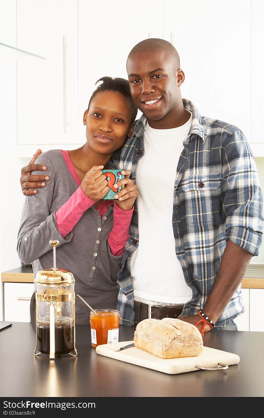 Young Couple Preparing Breakfast In Kitchen