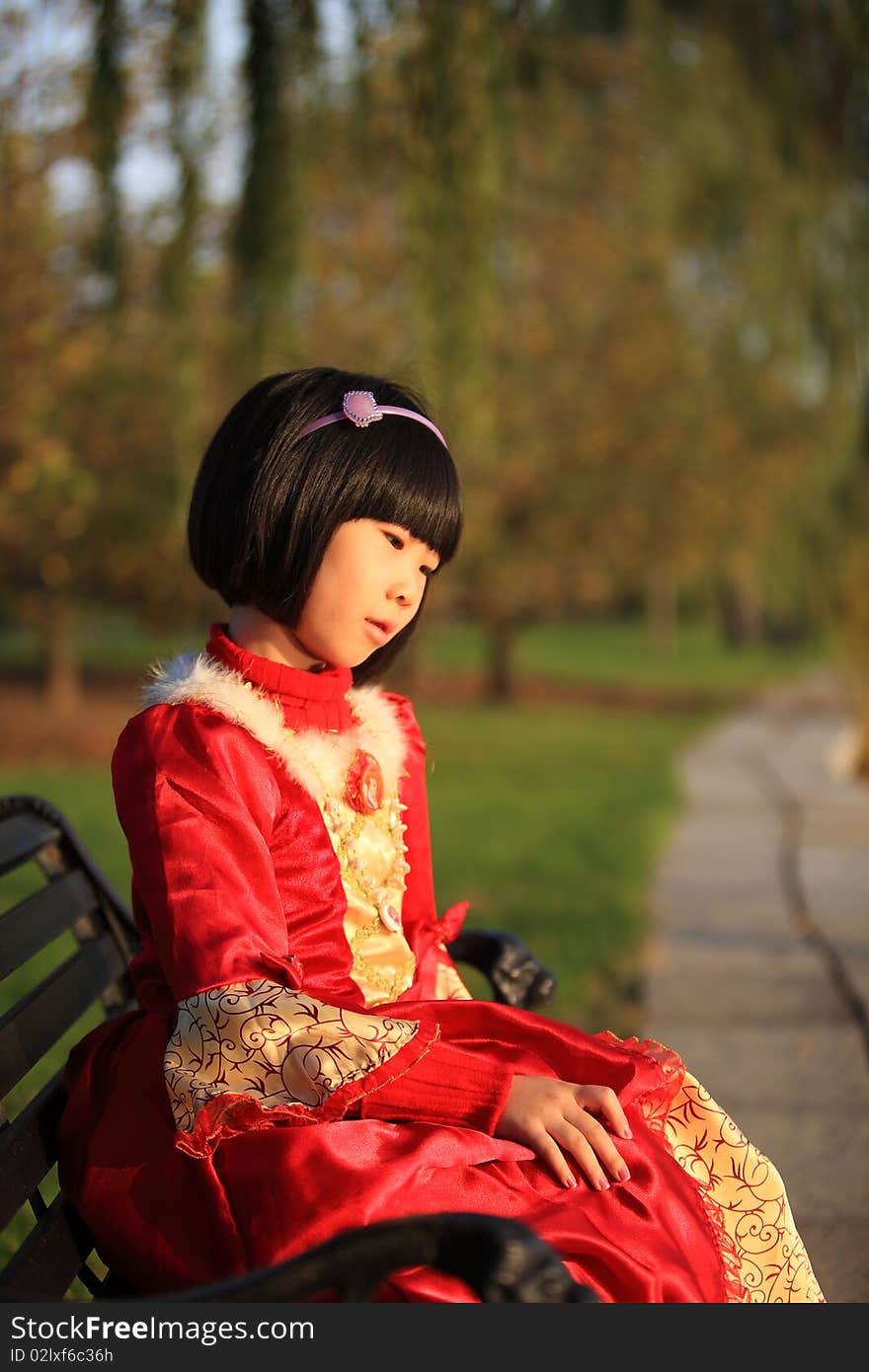 Asian Girl Sitting On Bench