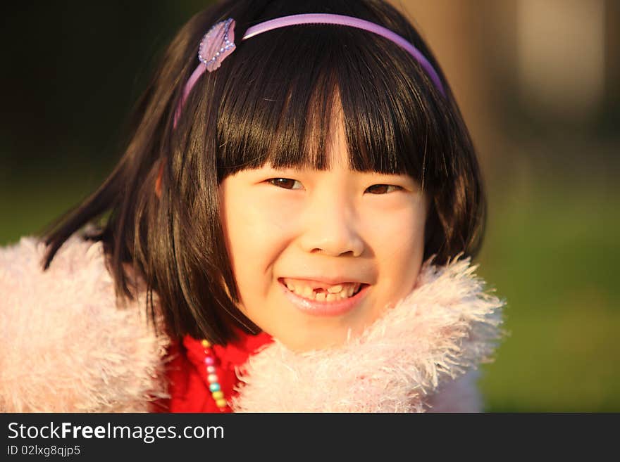 The little Chinese girl smiling in autumn. The little Chinese girl smiling in autumn