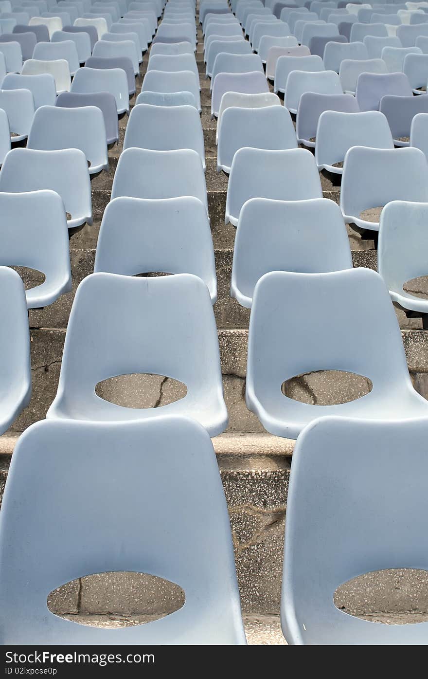 Many Empty Seats In Rows In An Outdoor Stadium. Many Empty Seats In Rows In An Outdoor Stadium