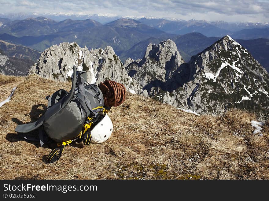 Mountains and climber backpack with helmet