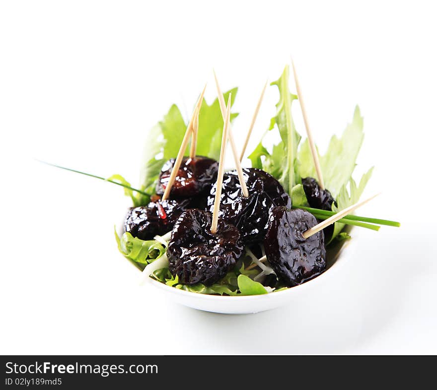 Bowl of greens and glazed prunes - studio. Bowl of greens and glazed prunes - studio