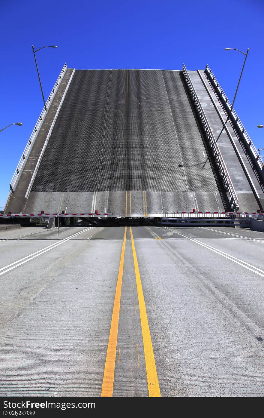 Bridge is raised for a passing push boat and its freight. Bridge is raised for a passing push boat and its freight.