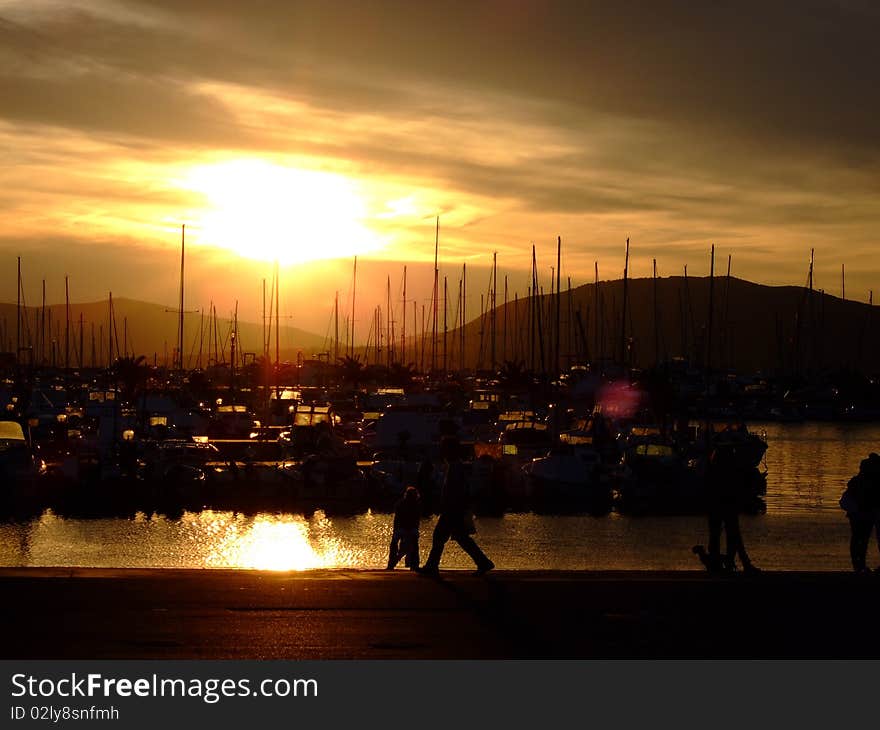 Dusk in seaport with interesting clouds in Alghero