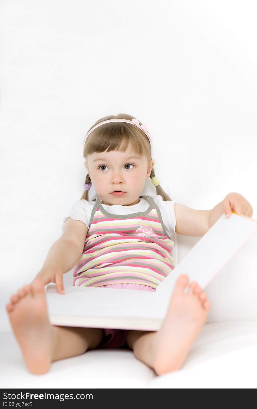 Sweet happy little girl reading book