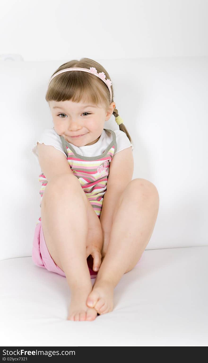 Happy little girl on sofa