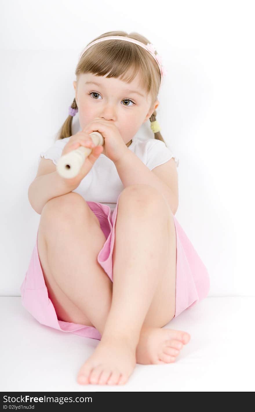 Sweet happy little girl with instrument