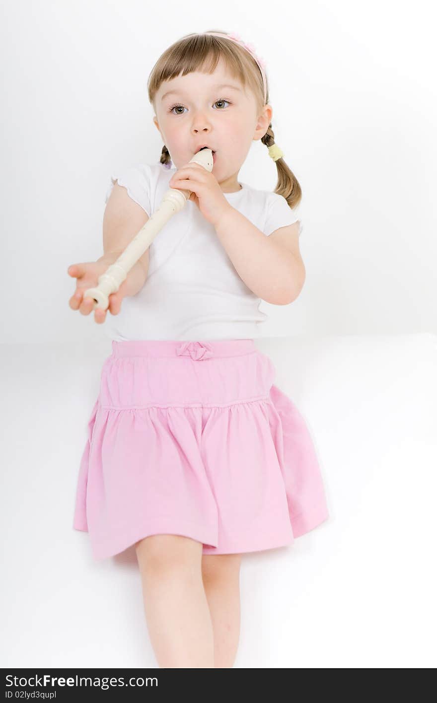 Sweet happy little girl with instrument