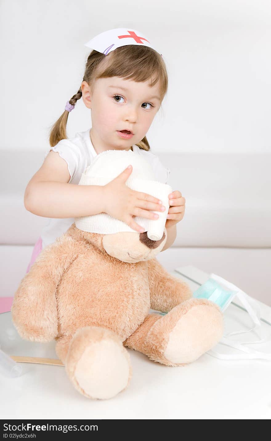 Sweet little girl doctor with teddy bear