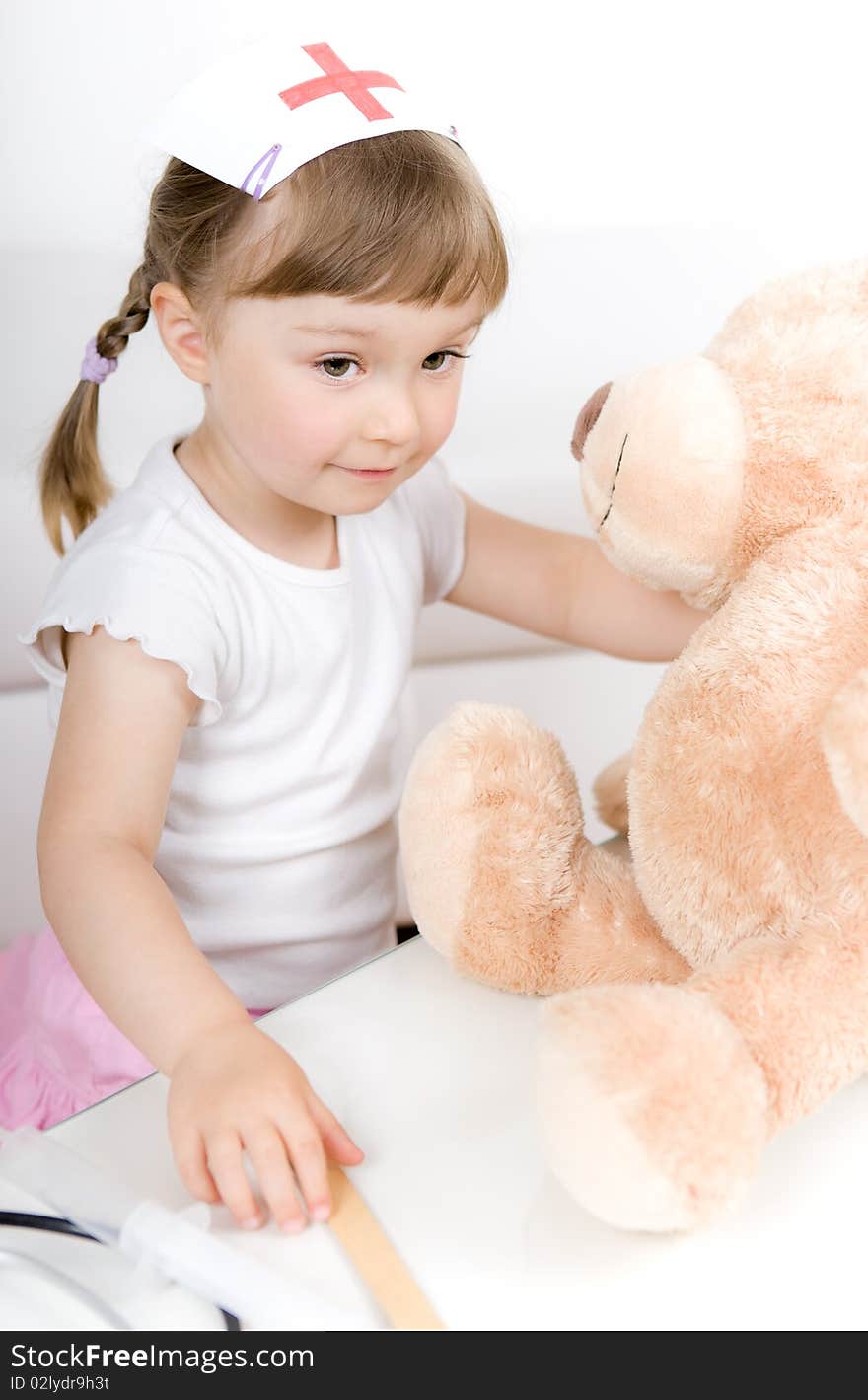 Little girl doctor with teddy bear