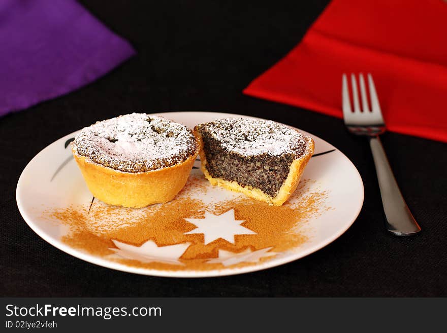 Two cakes presented on a white plate. Two cakes presented on a white plate