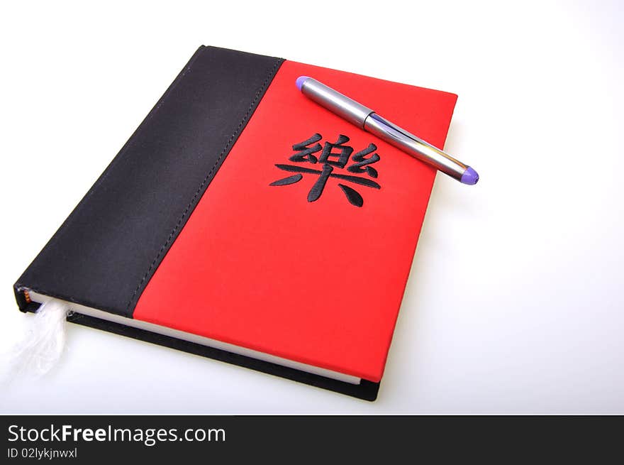 Oriental red and black diary with a pen