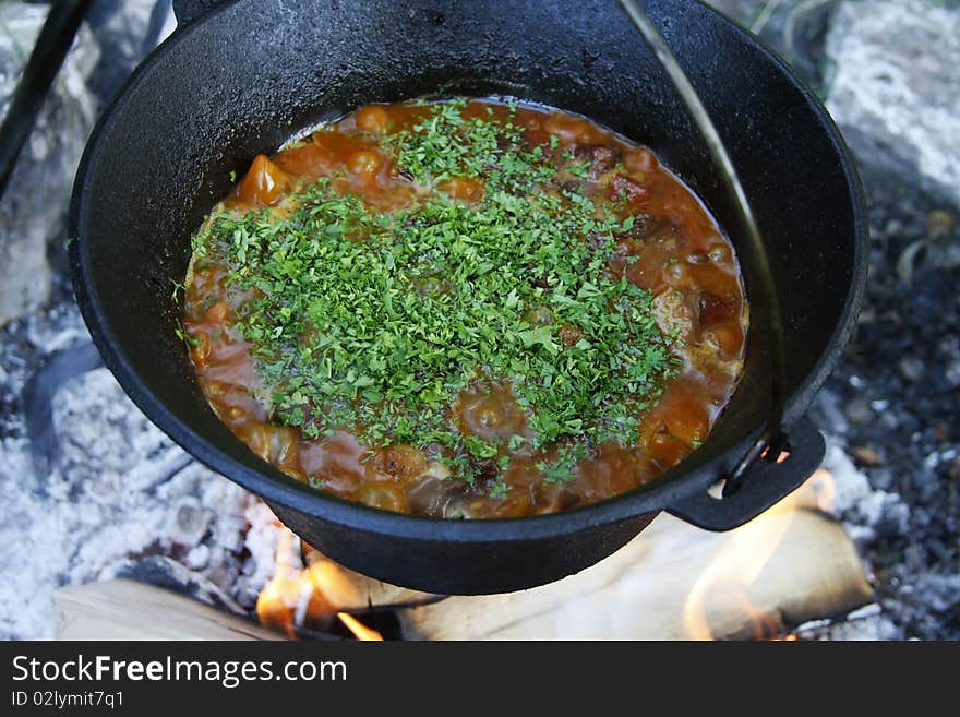 This picture represents an outdoor cooking session in a cauldron!