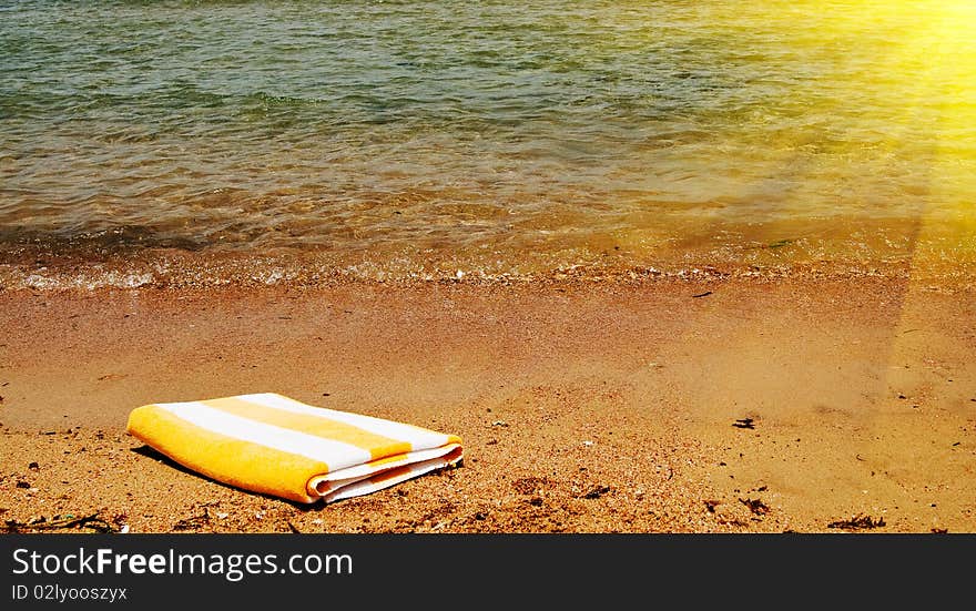 Sunbeams and beautiful towel next to the sea. Sunbeams and beautiful towel next to the sea.