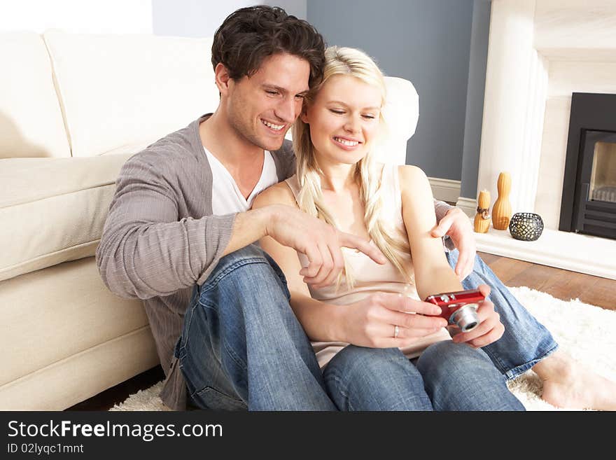 Couple Looking At Pictures On Digital Camera