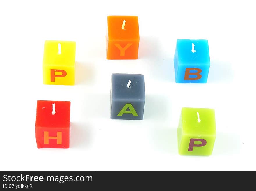 Colorful cubic candles with letters of the word Happy