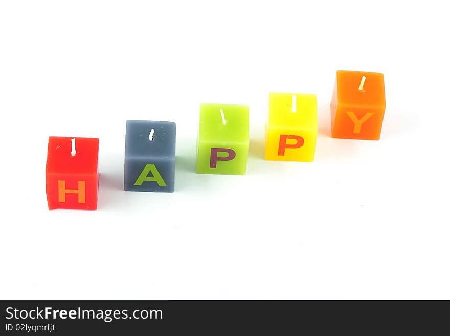 Colorful cubic candles with letters of the word Happy