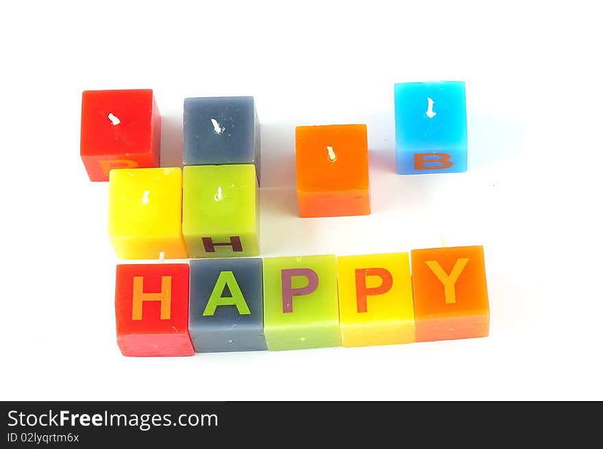 Colorful cubic candles with letters of the word Happy