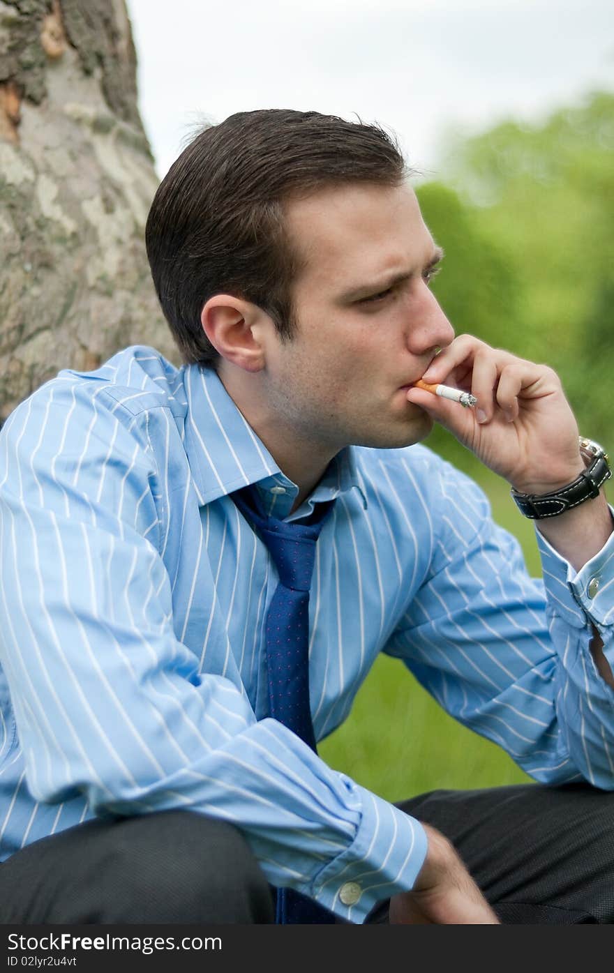 Young businessman smoking