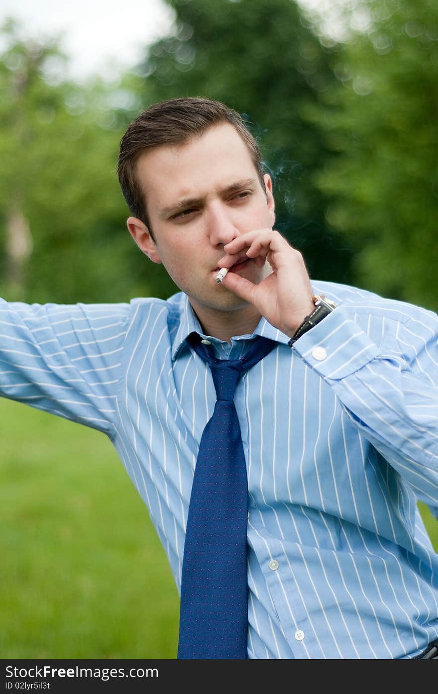 Young businessman smoking