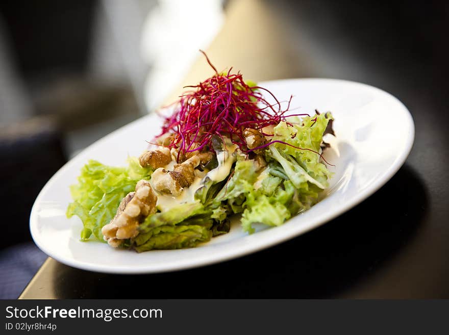 Beautiful, healthy mixed salad on a white plate. Beautiful, healthy mixed salad on a white plate