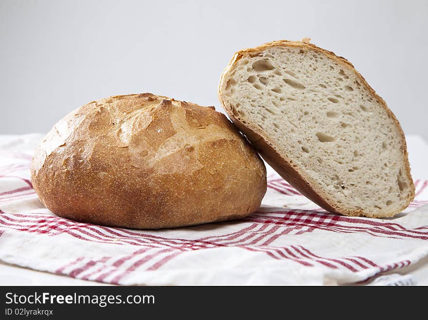 Fresh baked bread on a red and white cloth