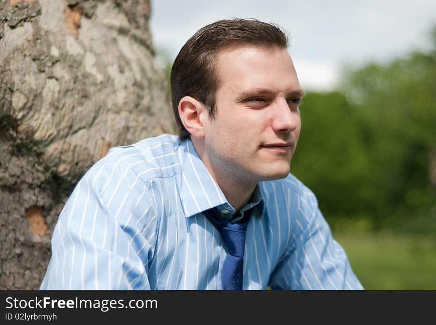 Happy young businessman in the sun