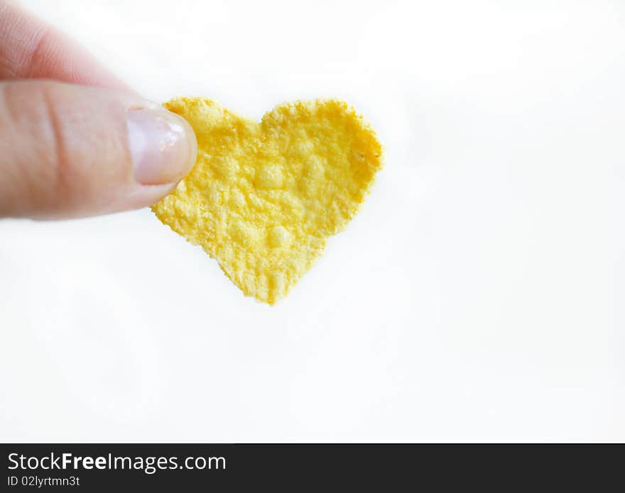 Cornflake like a heart in a woman hand. Cornflake like a heart in a woman hand