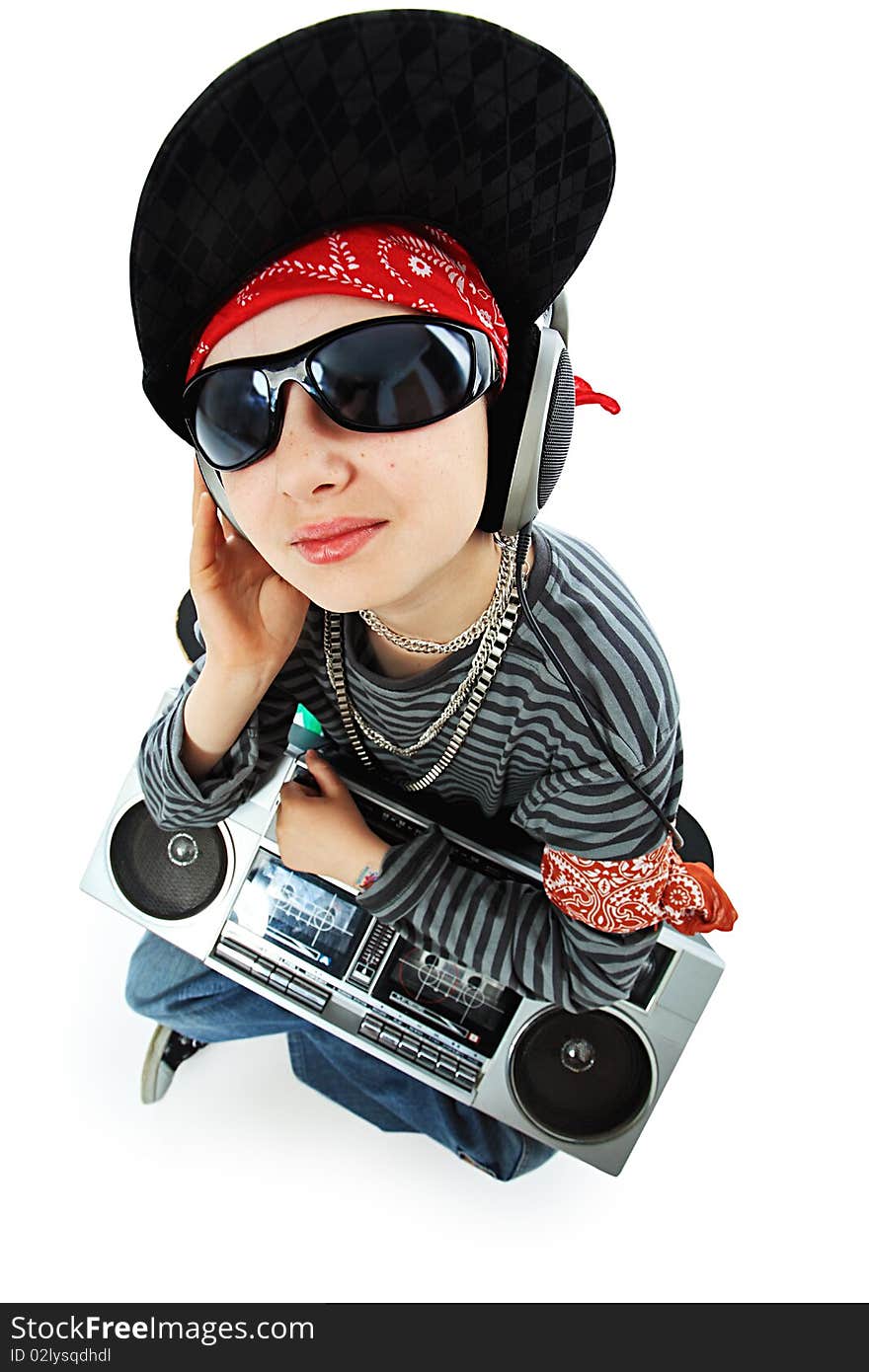 Shot of a trendy teenager listening to music in headphones. Isolated over white background. Shot of a trendy teenager listening to music in headphones. Isolated over white background.