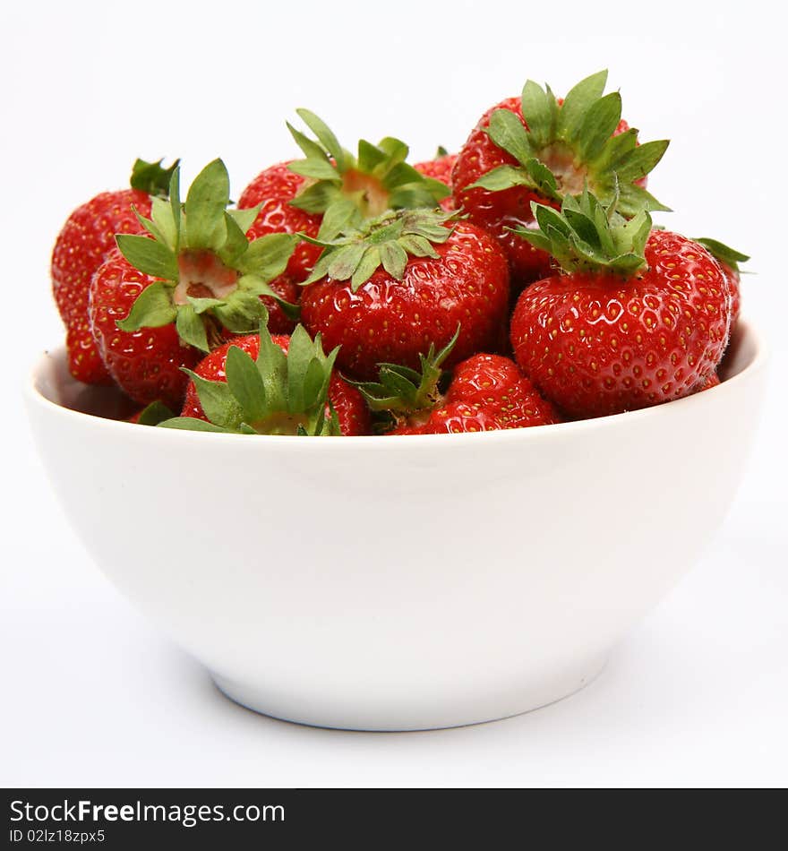 Strawberries in a bowl on white background