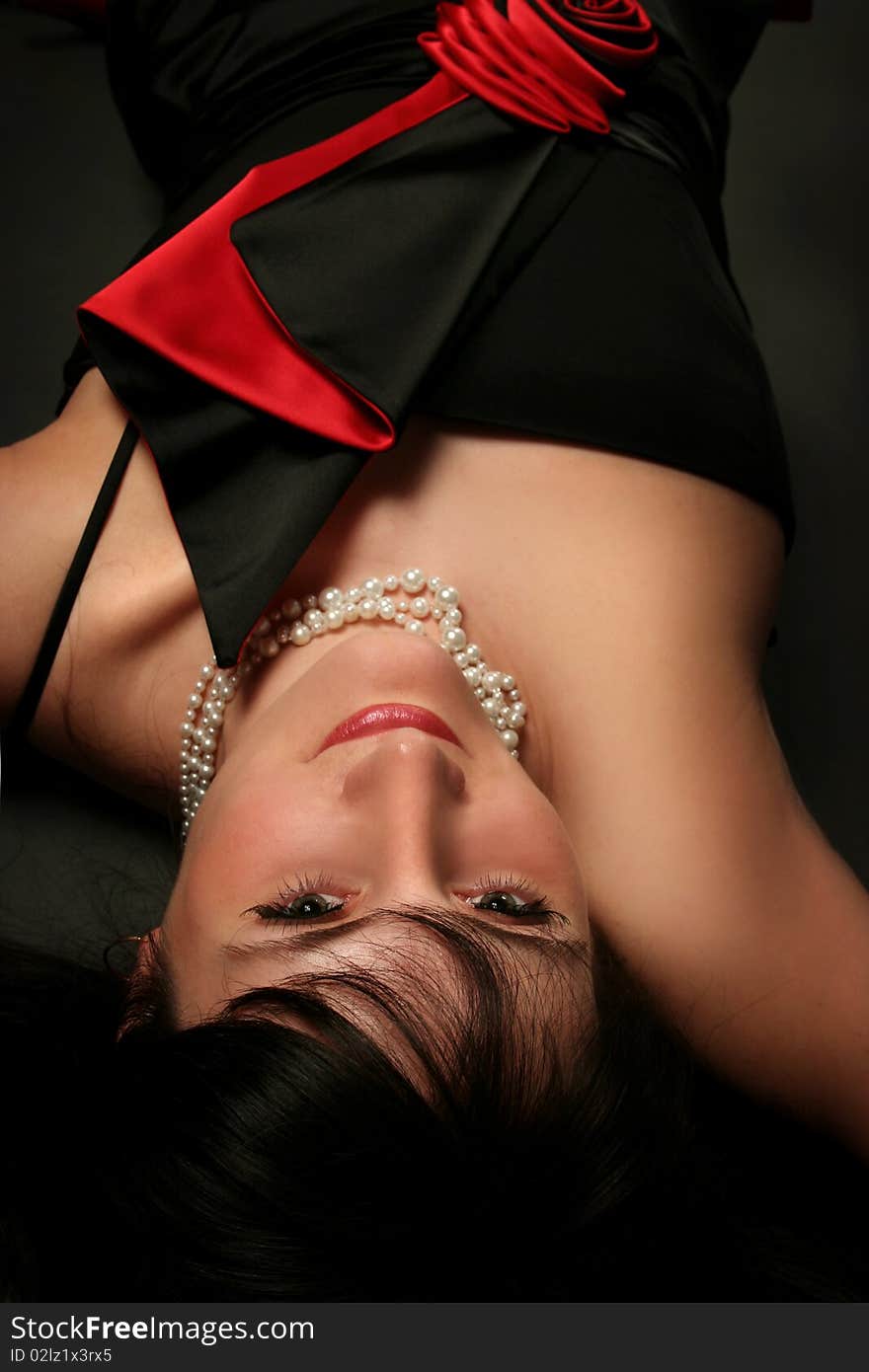 Sexy young woman lying on dark background. Sexy young woman lying on dark background