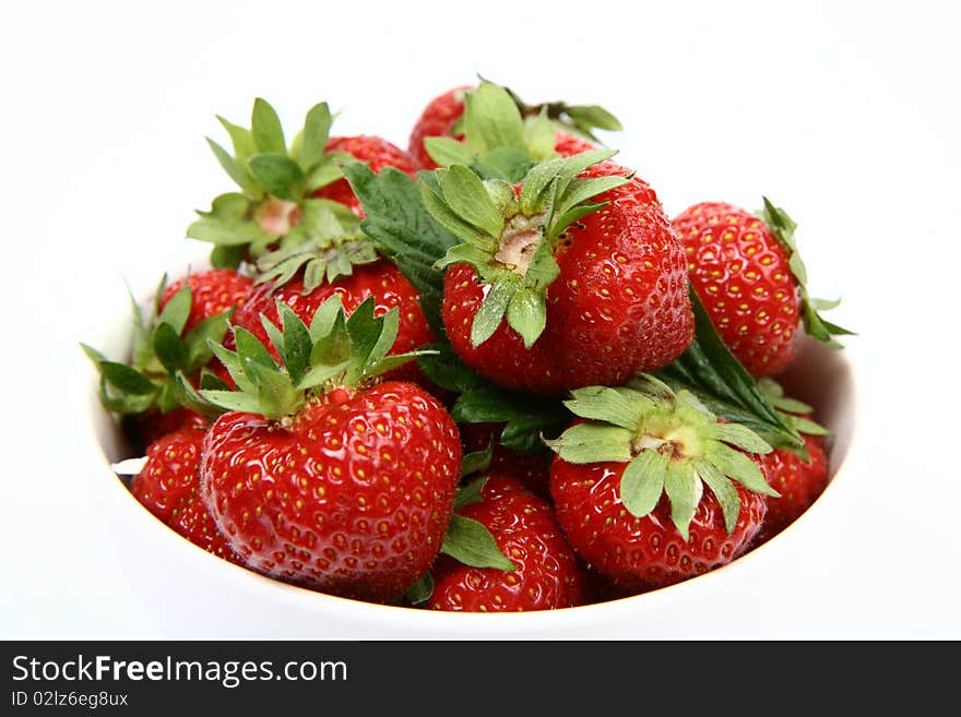 Strawberries in a bowl on white background