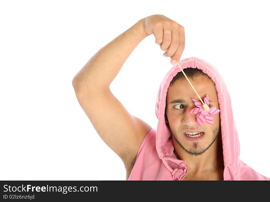 Unshaven young man holds weather vane before eye isolated in white