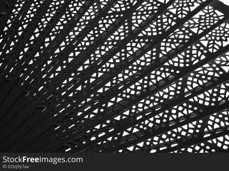 A black and white image of a Japanese fan. A black and white image of a Japanese fan