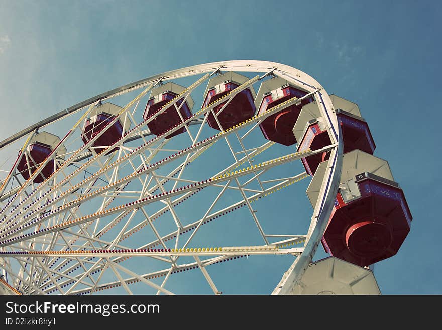 Looking up a ferris wheel with a blue sky background. Looking up a ferris wheel with a blue sky background