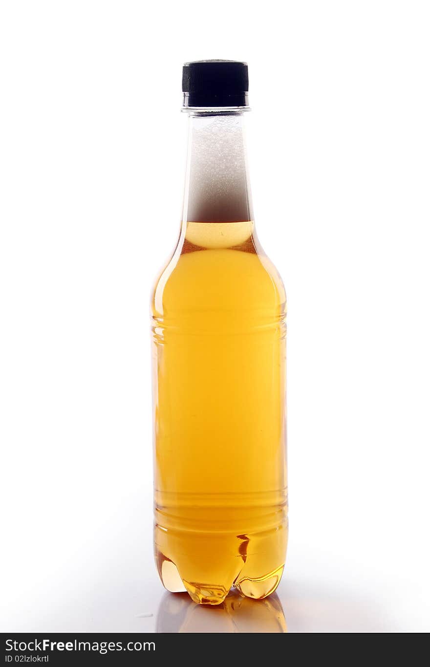 A bottle of beer is slanted with white background