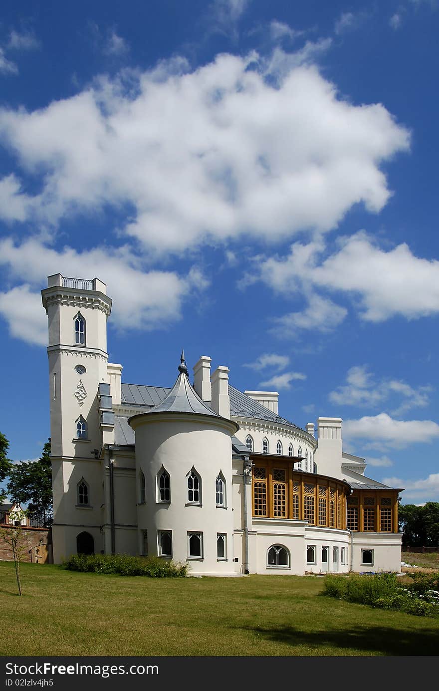 Gothic palace with the garden into a sunny day. Gothic palace with the garden into a sunny day