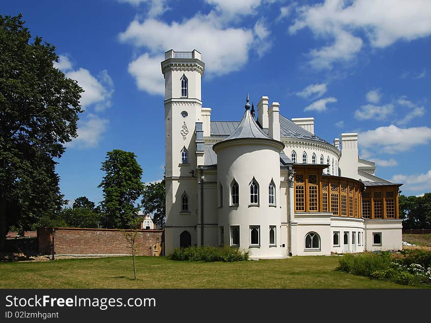 Gothic palace with the garden into a sunny day. Gothic palace with the garden into a sunny day