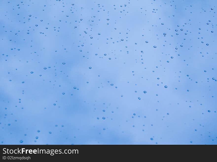 Raindrops on a background of blue sky