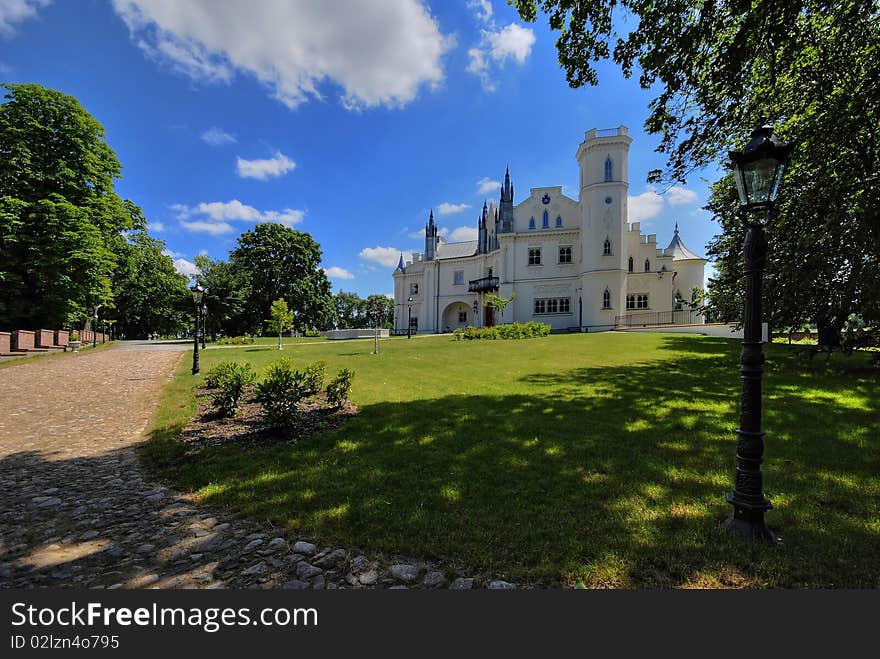 Gothic palace with the garden into a sunny day. Gothic palace with the garden into a sunny day