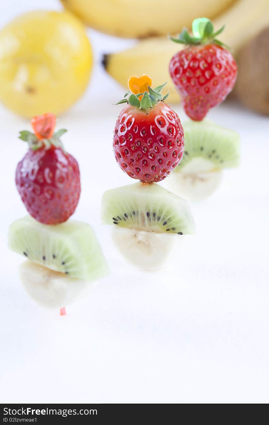 Close up of sliced fresh tropical fruits on white table top