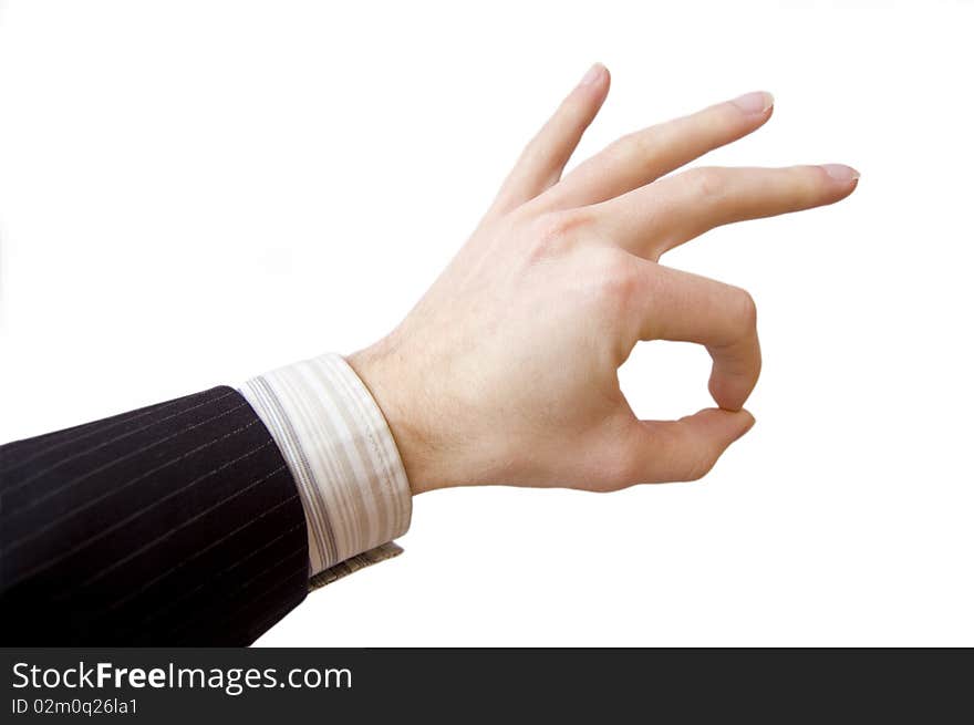 Success in business. Businessman hand shows the sign of victory.