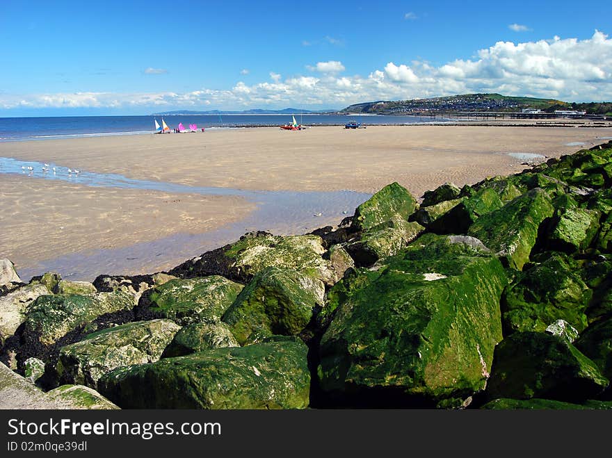 Stone beach defences bordering beach. Stone beach defences bordering beach