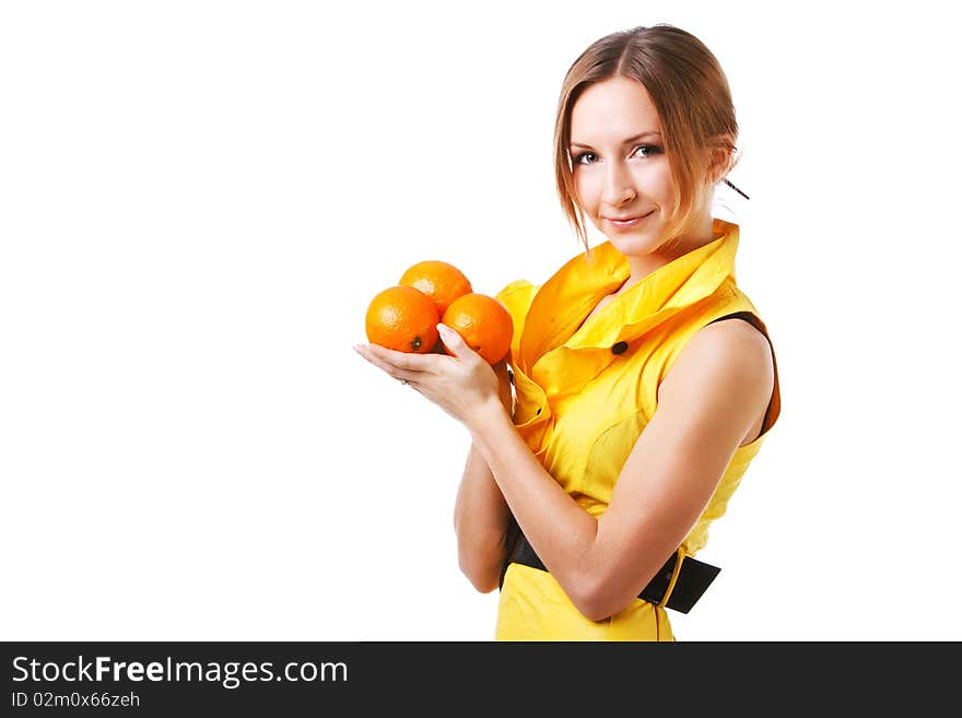 Young pretty girl in yellow dress with oranges