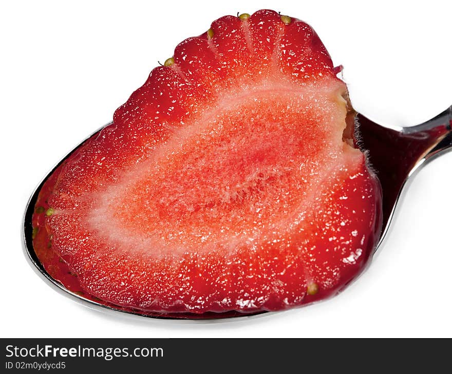 Strawberry in spoon isolated on white background